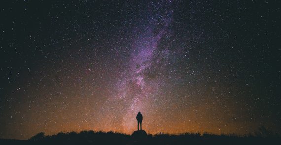 The Sanctity of Life (poem): person standing under starry night sky