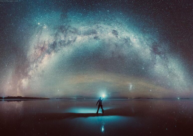 Man standing under bright stars at night, "Objects in Mirror" by Yonah ben-Avraham